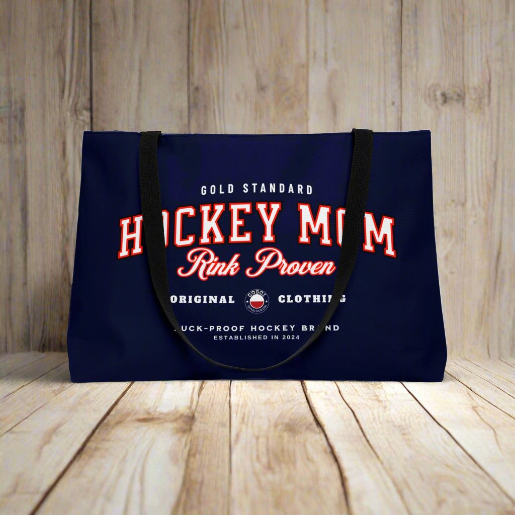 Rink Proven Hockey Mom weekender - GoBoi Store - Hockey Mom weekender tote bag is perfect for those who need to bring along a little bit of everything but prefer to travel light. The classic design pairs beautifully with any outfit, whether you're heading to the rink, a shopping spree, or the beach. This lightweight yet durable tote is spacious enough to easily fit a fleece blanket and all your rink-day essentials. Black interior lining, black handles T-bottom construction Assembled in the USA