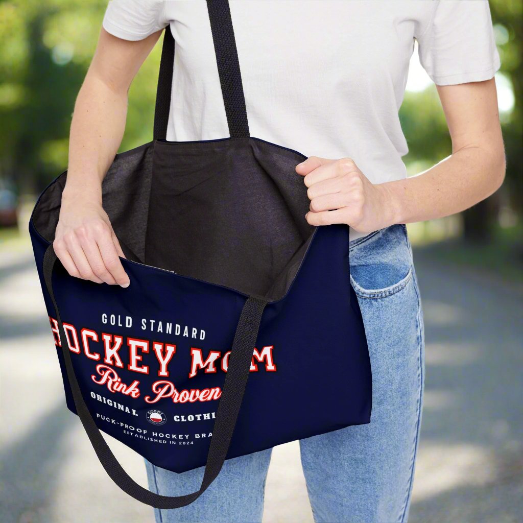 Rink Proven Hockey Mom weekender - GoBoi Store - Hockey Mom weekender tote bag is perfect for those who need to bring along a little bit of everything but prefer to travel light. The classic design pairs beautifully with any outfit, whether you're heading to the rink, a shopping spree, or the beach. This lightweight yet durable tote is spacious enough to easily fit a fleece blanket and all your rink-day essentials. Black interior lining, black handles T-bottom construction Assembled in the USA
