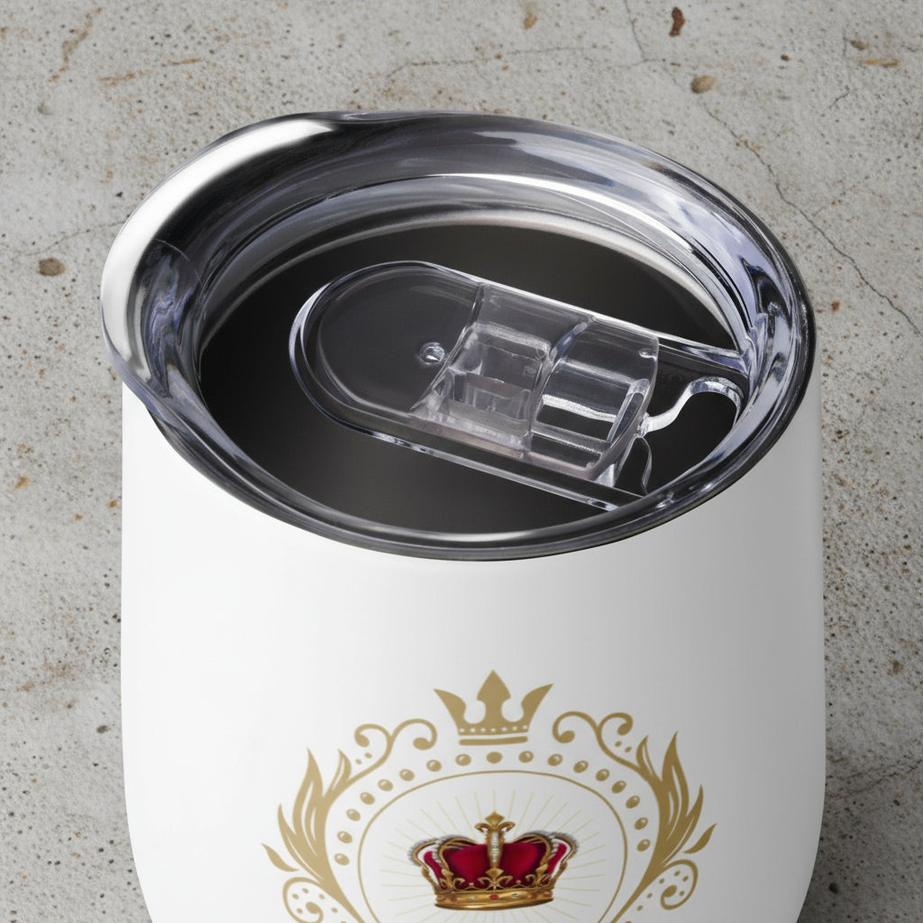 White tumbler with gold crown design and clear lid on a white background